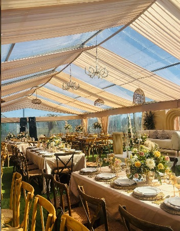 Marquee wedding reception with gold and ivory styling